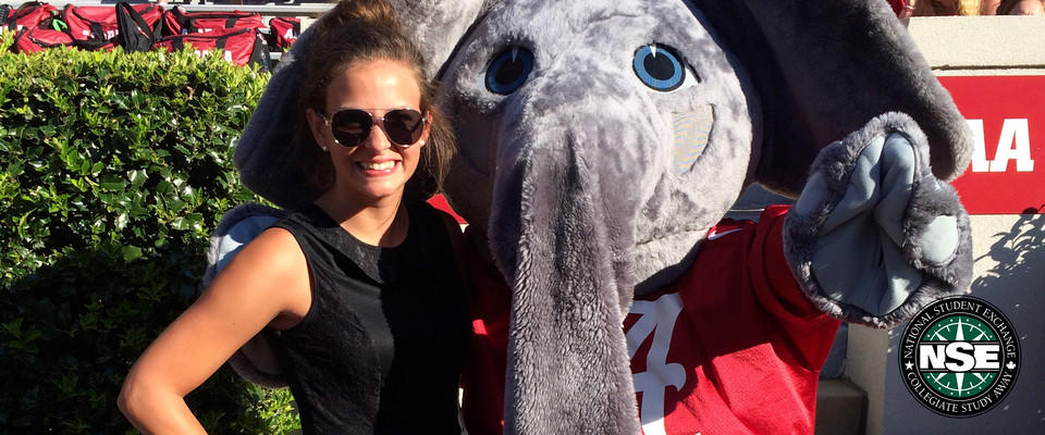 NSE student poses with an elephant mascot